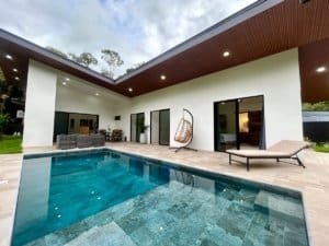 Contemporary tropical home with private pool and outdoor lounge area.