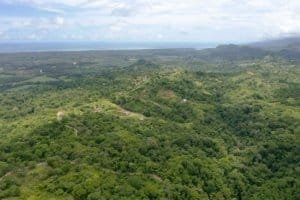 Lush green forest with river and hills in Dominical, Costa Rica.