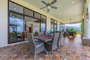 Covered outdoor patio with dining area and scenic ocean view in Costa Rica.
