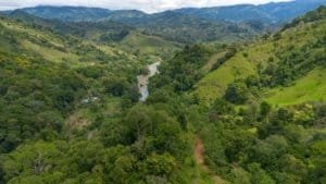 Lush green mountains and river in Dominical, Costa Rica.