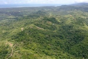 Lush green forest with river and hills in Dominical, Costa Rica.