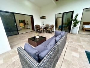 Spacious indoor-outdoor living area with pool, dining, and bedroom in Dominical.