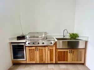 Contemporary kitchen with wooden cabinets, sink, and grill in Dominical.