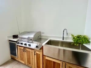Contemporary kitchen with stainless steel sink and wooden cabinets.