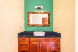 Modern bathroom vanity with mirror and sink in Dominical property.