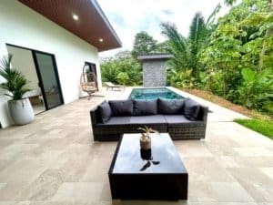 Luxury tropical home with pool, outdoor seating, and lush garden in Dominical.