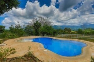 Scenic pool with lush greenery and mountain backdrop in Dominical, Costa Rica.