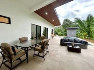 Spacious outdoor patio with dining and lounge area in Dominical, Costa Rica.