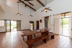 Bright interior with high ceilings, wooden beams, and large windows in Dominical.