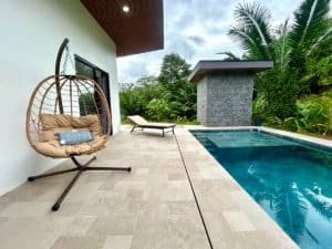 Luxury Costa Rica home with pool, outdoor lounge, and lush greenery.