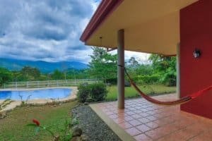 Hacienda style home with porch, hammock, pool, and mountain view in Costa Rica.