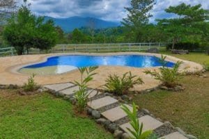 Beautiful pool with mountain view and lush garden in Dominical Costa Rica.