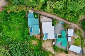 Aerial view of a modern tropical home with pool surrounded by lush greenery in Dominical.