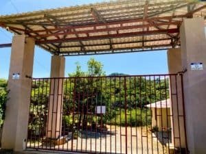 Entrance gate to lush jungle with mountain views in Dominical, Costa Rica.