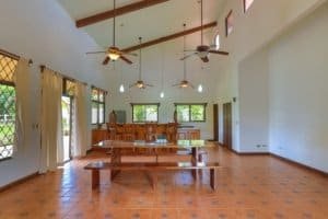 Bright, open living space with high ceilings and wooden accents in Dominical.