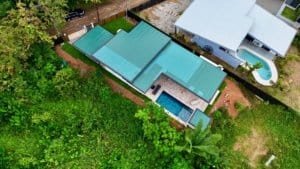 Aerial view of a modern tropical home with pool and lush greenery in Dominical.