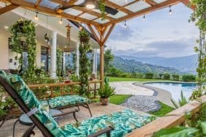 Beautiful outdoor patio with ocean view, pool, and lush garden in Costa Rica.