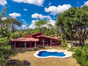 Beautiful hacienda style home with pool, stables, and lush greenery in Dominical.