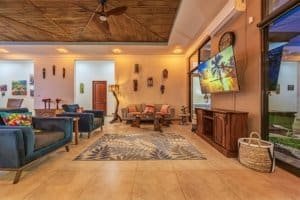 Spacious living room with ocean view, colorful art, and modern furniture in Dominical.