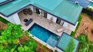 Aerial view of a modern tropical home with private pool and lush garden in Dominical.