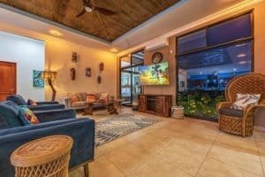 Elegant living room with ocean view, tropical decor, and modern amenities.