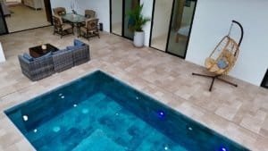Luxury tropical home with private pool and outdoor seating area.