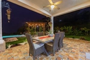 Outdoor dining space with table, chairs, and garden view in Dominical.