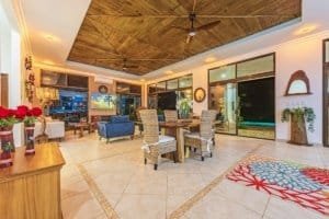 Spacious living room with ocean view, modern decor, and outdoor access.