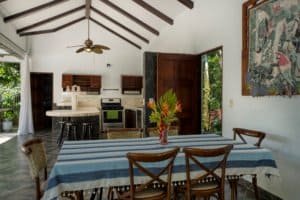 Interior view of a Bali style home with high ceilings, wooden beams, and tropical decor.