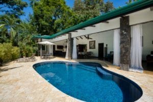 Beautiful Bali style home with pool, outdoor living area, and lush greenery in Dominical.