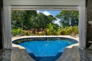 Beautiful pool overlooking lush tropical garden in Dominical, Costa Rica.