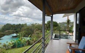 Balcony overlooking lush green mountains and trees in Dominical, Costa Rica.
