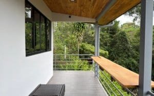 Balcony with wooden ceiling and mountain scenery in Dominical, Costa Rica.