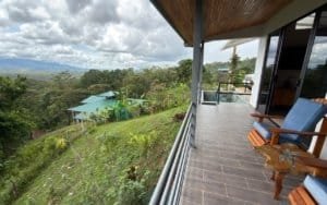Balcony with mountain views and lush greenery in Dominical, Costa Rica.