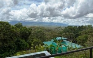 Scenic mountain view with tropical trees and a house in Dominical.