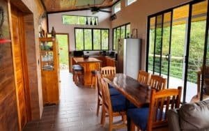 Interior of a mountain view home with dining area and large windows.