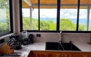 Modern kitchen with mountain view and large windows in Dominical.