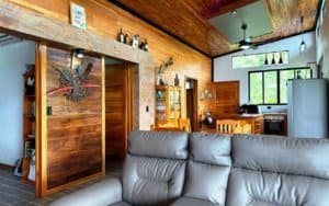 Interior of a cozy Costa Rican home with wooden walls and modern furnishings.