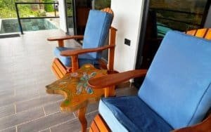 Outdoor balcony with wooden chairs and mountain view in Dominical.