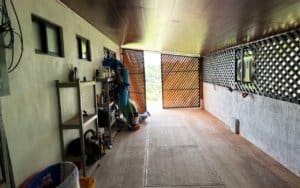 Large covered patio with mountain views and storage shelves in Dominical, Costa Rica.