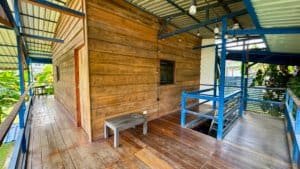 Wooden house with an outdoor deck and stairs in Costa Rica real estate.