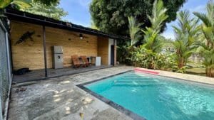 Small pool with patio, tropical plants and wooden structure in Dominical.
