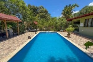 Beautiful pool with lush jungle surroundings and tropical trees in Dominical.