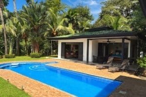 Dominical real estate: swimming pool, tropical landscaping and outdoor pavilion.