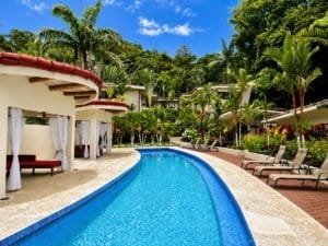 Luxury resort pool with garden view and tropical trees in Dominical Costa Rica.