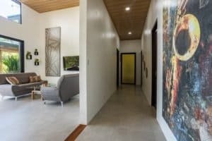 Spacious living area and hallway in a modern Costa Rica home with artwork.
