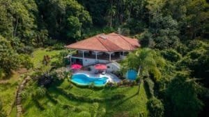 Aerial view of a luxury home with pool and lush greenery in Dominical, Costa Rica.