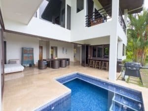Modern Costa Rican home with private pool, outdoor seating, and lush garden.