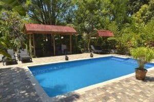 Beautiful pool with jungle surroundings and shaded cabanas in Dominical.