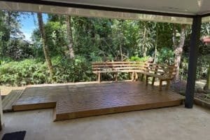 Deck with wooden seating and lush tropical garden in Dominical area.